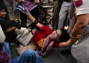 AISA President Neha Bora being taken into custody during the protest against Chief Election Commissioner Gyanesh Kumar.